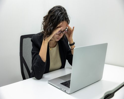 person experiencing eye fatigue from computer work